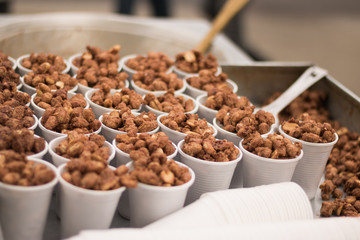 Popular fried nuts are sold in a street or other public location for immediate consumption as a snack. Street food it is popular fast food in our days in a city. 
