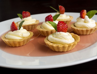 Many mini tarts with berries