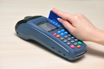 Girl pays purchase through the terminal pos