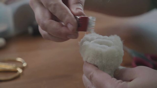Teddy bear: the process of creation. Female hands sew parts of a toy. Handmade. Details of teddy bear. A rare collectible toy is a teddy bear. Favorite toy of children is a teddy bear.