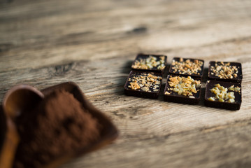 Chocolate bar pieces with cocoa powder. Background with chocolate. Slices of chocolate, Copyspace