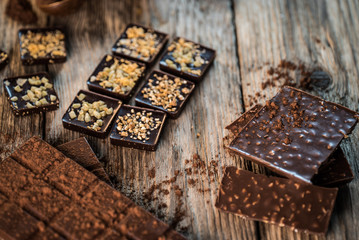 Chocolate bar pieces with cocoa powder.  Background with chocolate. Slices of chocolate,  Copyspace