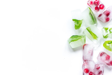 ice cubes with red berries and mint top view white background mockup