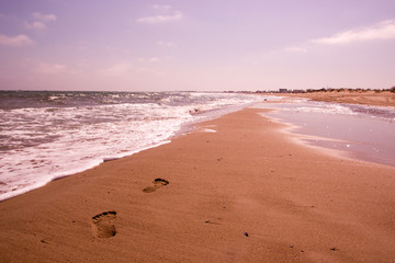 Human footprint Seaside at day time with blue sky and clouds