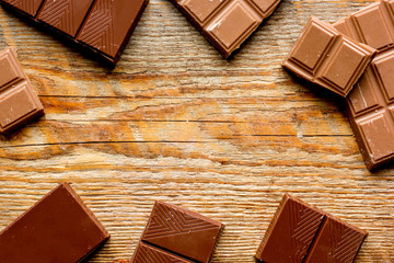 black and milk chocolate bars dark wooden table background top view mockup