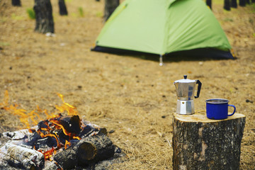 Camping in the forest. Preparation of breakfast at the stake.
