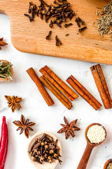 Dry colorful spices, vanilla, cinnamon on kitchen stone table background top view