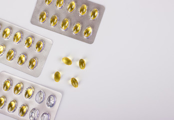 fish fat oil capsules, drugs capsules in blister on white background.