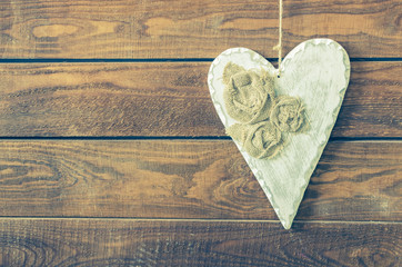 White heart on a rustic wooden background.
