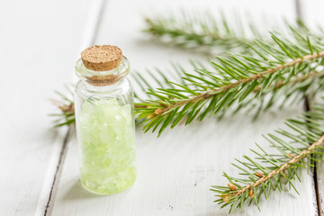 fir branches and spruce bath salt on white table background