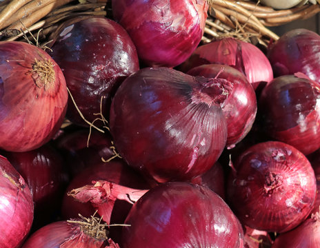Pile of Vibrant Color Fresh Red Onions in the Basket