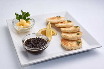 Black caviar. Lemon. Greens. Bread and butter