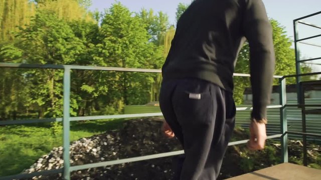 Street parkour with runs and jumps on bridge by stuntman