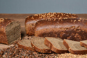 Fresh sliced bread with seeds on gray background