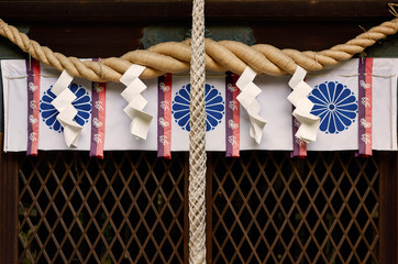 Japanese shinto shrine shimenawa purification rope with shide paper streamers