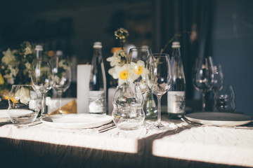 Beautiful served wedding table with decor as candles, flower arrangements. Banquet dinner party