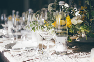 Beautiful festive table setting, closeup. Wedding festive interior, table decorations, flowers, table setting, wine glass, pastel summer tones