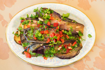 Pickled eggplants and carrots in a white plate