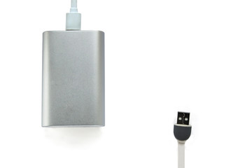 Grey portable external battery ( power bank ) with usb cable isolated on white background