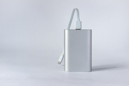 Grey portable external battery ( power bank ) isolated on a white background