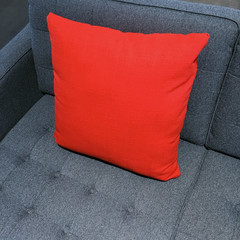 Vibrant red cushion decorating gray sofa