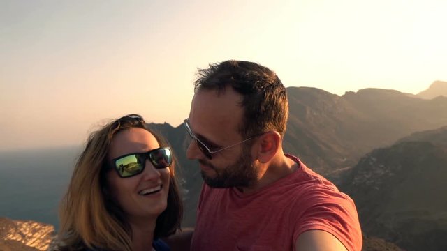 Happy couple recording video, taking selfie in the mountains
