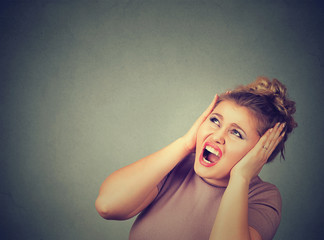 Stressed frustrated woman covering her ears