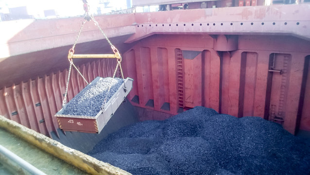 The cargo compartment of the ship, filled with coal. Loading of