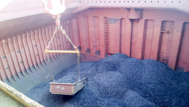 The cargo compartment of the ship, filled with coal. Loading of