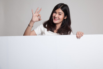 Fototapeta premium Young Asian woman show OK with blank sign.