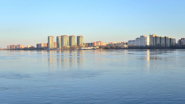 View of Neva river and microdistrict Ribatskoe on the outskirts of St. Petersburg, Russia. Timelapse 4K. Slight fluctuations of camera due to windy weather.