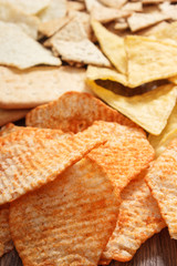 Heap of salted potato crisps and cookies, concept of unhealthy food