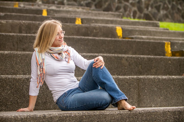 outdoor portrait of young happy girl on neutral urban background