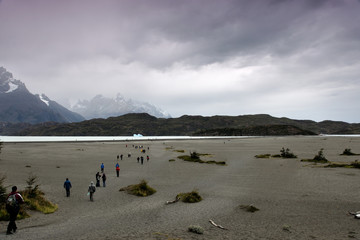 tourists visit Lago Grey in Torres del Paine national park, Chile