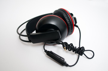 Black and red headphones on white background
