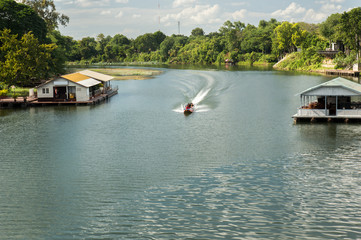 Naklejka premium Transportation by long-tail boat in Kanchanaburi Province of Thailand.