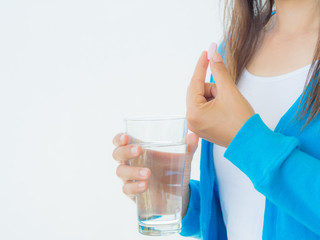 medicine, health care and people concept - close up of woman taking in pill