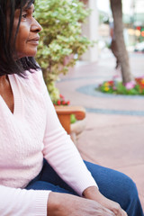 Naklejka premium African American senior woman sitting on a bench.