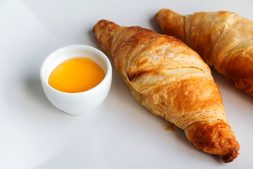 French breakfast - croissants and honey. Closeup.