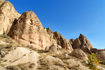 View of cave houses in valley at Cavusin. Cappadocia. Turkey