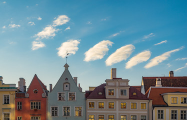 Colorful medieval houses against wonderful clouds