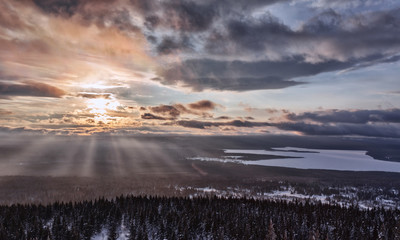 Obraz premium Winter landscape in the mountains. Clouds in the sky, sunny day. Lots of snow, frost, cold space. Ural Mountains, Russia. Sunset in the mountains