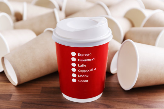 Red Paper Coffee Cup With Brown Paper Cups Background