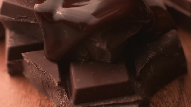 Melted chocolate pouring over chunks of chocolate in super slow motion, shot on Phantom Flex 