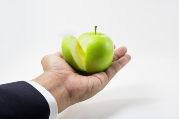 Business market share concept.Green apple slice on businessman hand.