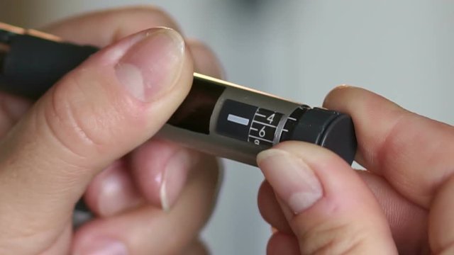 Girl Picks Up Right Dose Of Insulin On Syringe Pen, Close-up. Slow Motion.