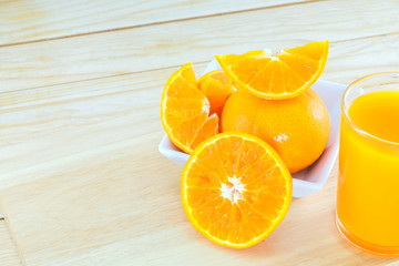Close-up ripe orange on wood background.