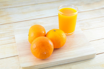 Close-up ripe orange on wood background.