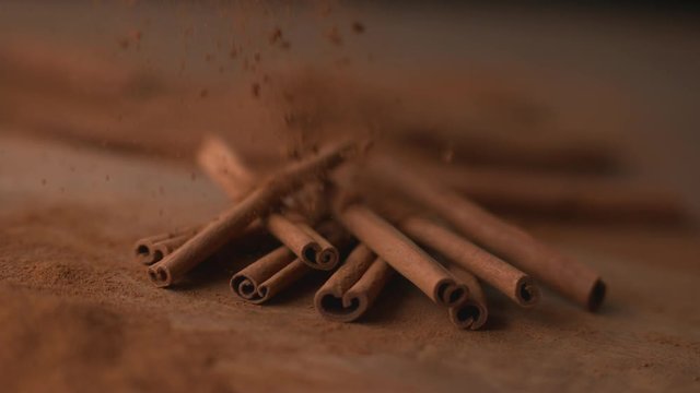 Cinnamon falling onto cinnamon sticks in super slow motion, shot on Phantom Flex 