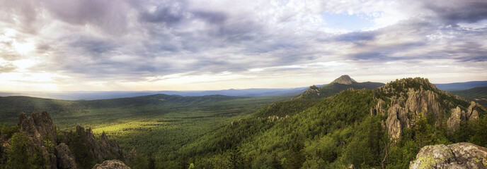 Fototapeta na wymiar Panoramic view of the mountains and cliffs, South Ural. Summer in the mountains.